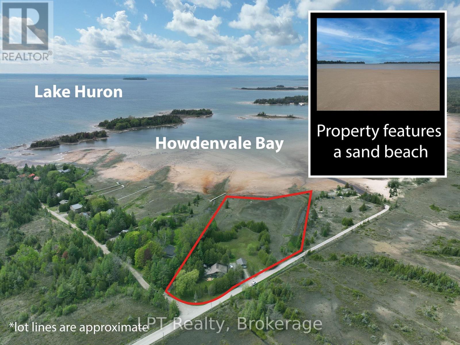 Aerial view of the property showing its own sand beach on Howdenvale Bay