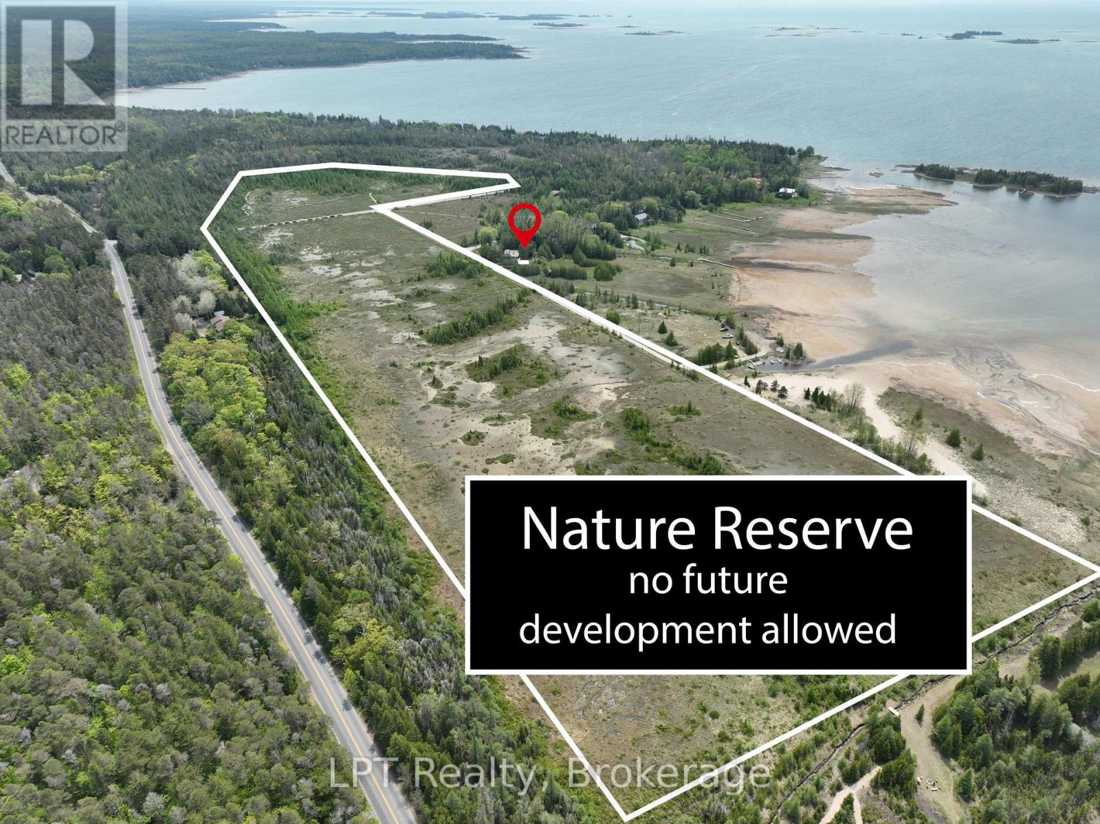 Aerial view of the property within the surrounding nature reserve and shoreline